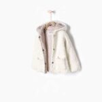 Knitted three quarter length coat with hood