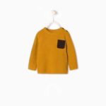 Knit sweater with suedette pocket
