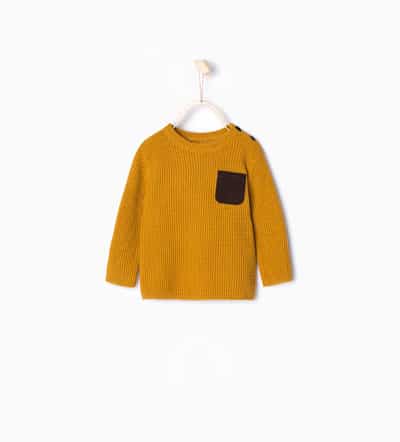 Knit sweater with suedette pocket
